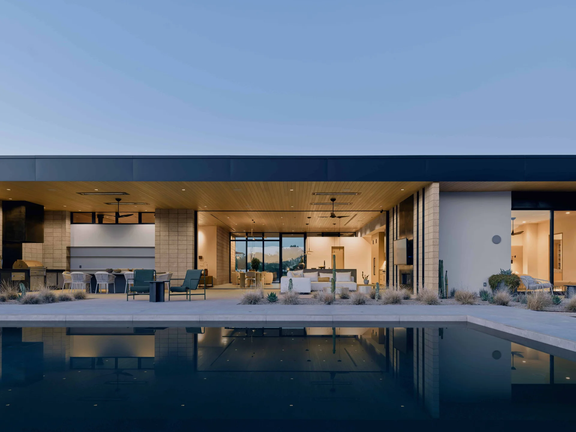 Doubletree residence rear exterior with pool and covered patio at twilight